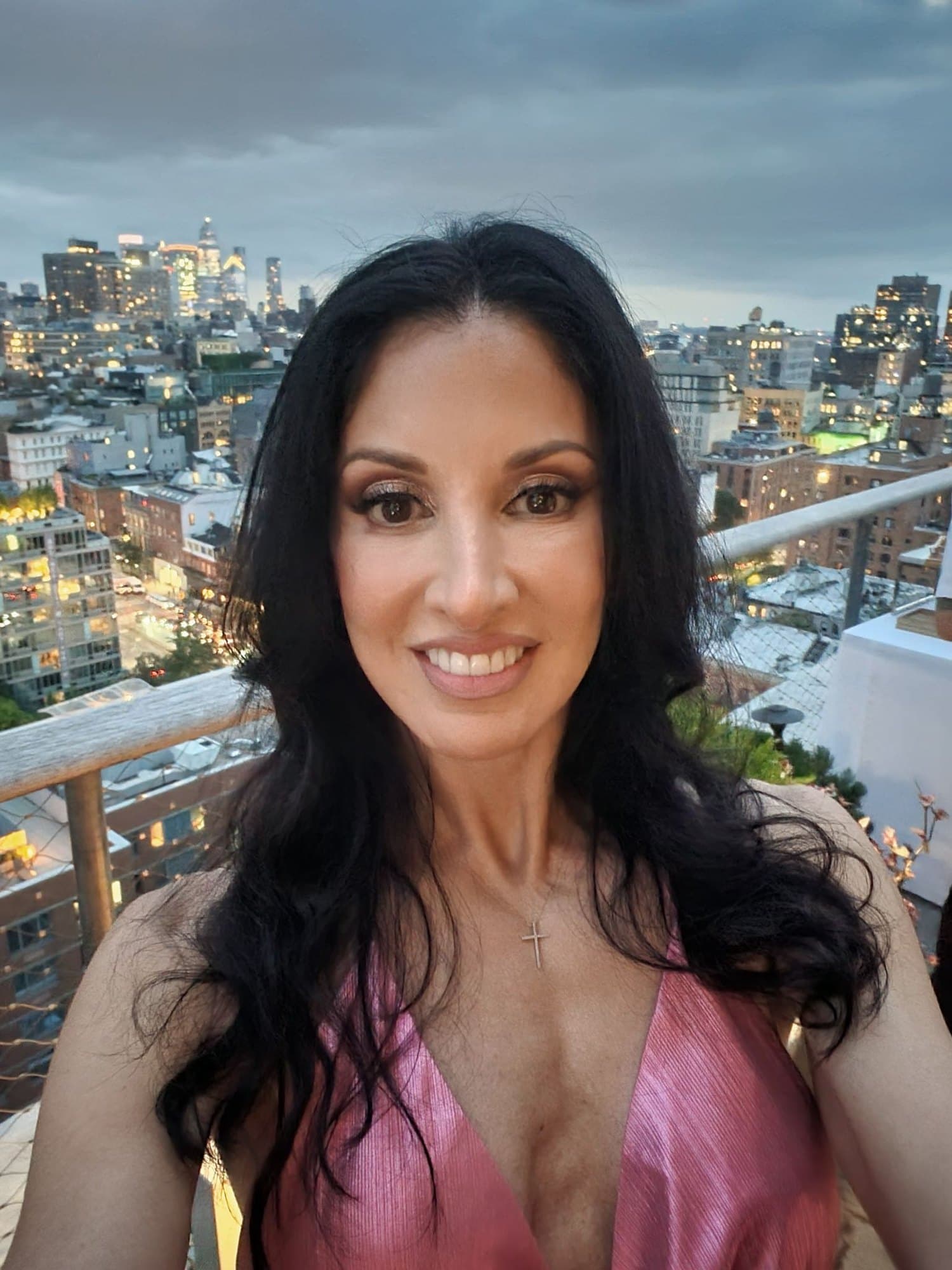 Mary Josephine Generoso (@realmjmetax) on a New York rooftop at dusk, wearing a pink dress